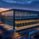 European AI gigafactory campus with large accelerator data halls at dusk